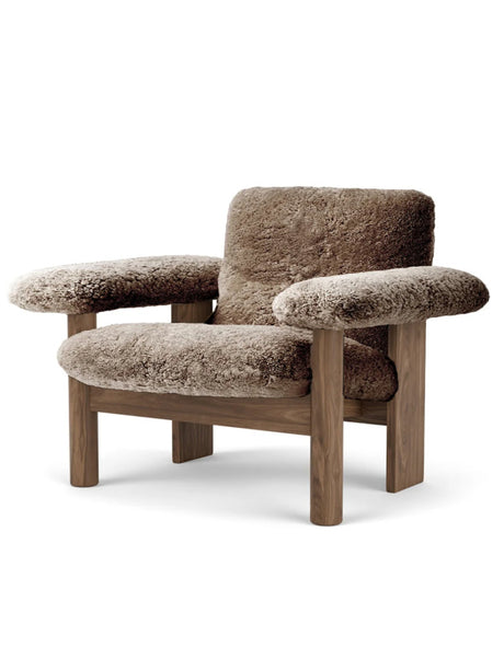 Brown upholstered armchair with wooden frame. Audo Copenhagen. www.oroa.com