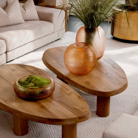 Wooden coffee tables with decorative items in a living room setting